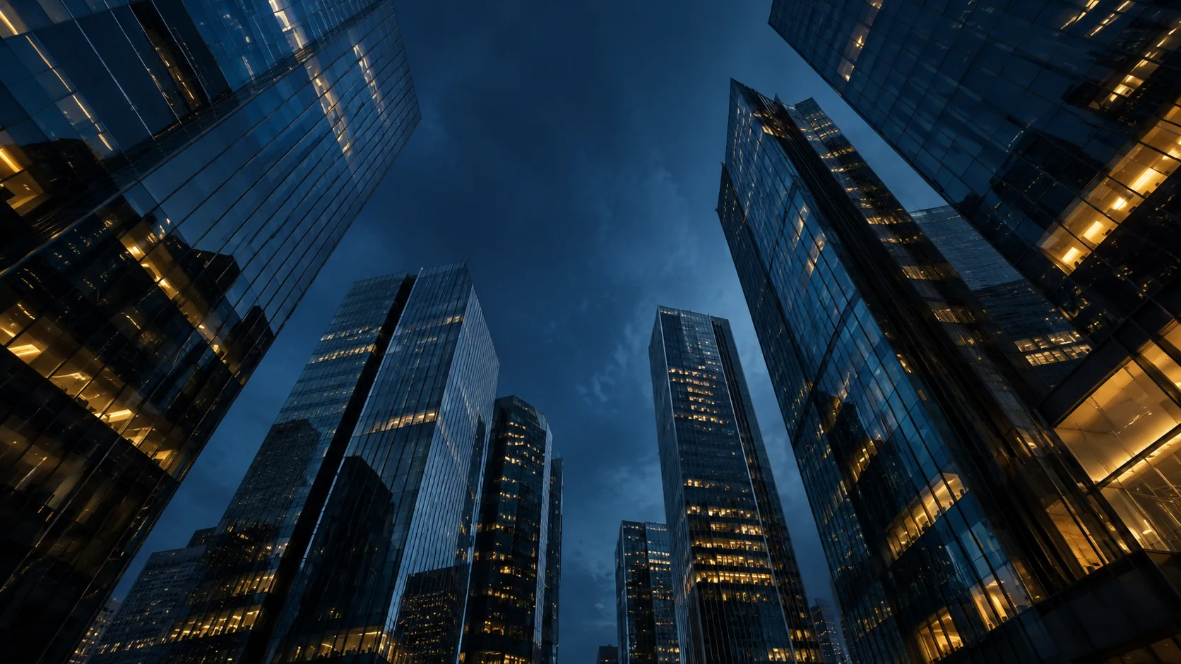 Modern office towers with warm illuminated windows.